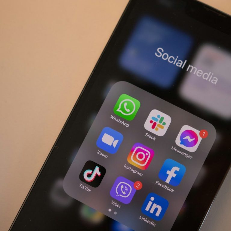 Smartphone screen displaying social media apps including WhatsApp, Instagram, and Facebook.